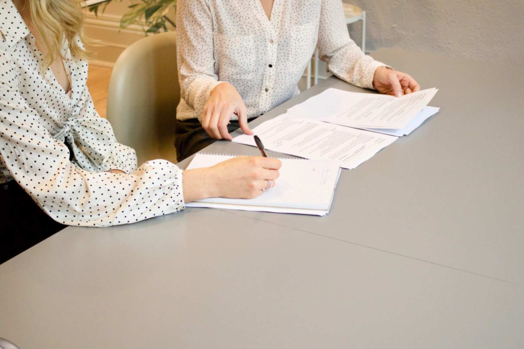 Two people reviewing documents together